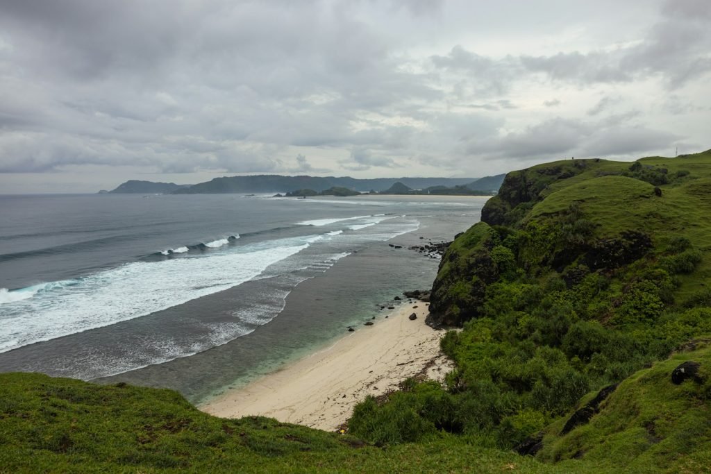 a beach with a body of water by it